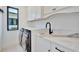 Efficient laundry room with modern appliances, marble countertops, and ample storage solutions for a seamless laundry experience at 5939 Redbay Blvd, Bradenton, FL 34210