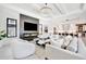 Modern living room featuring a fireplace, TV, elegant chandelier, and an open layout into the kitchen at 5939 Redbay Blvd, Bradenton, FL 34210