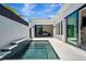 Outdoor pool with tiled steps and views of the bedroom through sliding glass doors enhance the home's modern design at 5939 Redbay Blvd, Bradenton, FL 34210