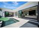 Outdoor patio with pool and views of the house's modern design, glass doors, and sleek architectural details at 5939 Redbay Blvd, Bradenton, FL 34210