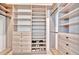 Spacious walk-in closet with custom shelving, drawers, and hanging rods for optimal organization and stylish storage at 5939 Redbay Blvd, Bradenton, FL 34210