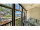Relaxing screened-in balcony with a cozy dining area, offering stunning waterfront views and fresh air at 6157 Midnight Pass Rd # B42, Sarasota, FL 34242