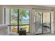 Picturesque view from the condo balcony overlooking waterfront scenery, lush greenery, and a private fishing pier at 6157 Midnight Pass Rd # B42, Sarasota, FL 34242