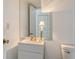 Cozy bathroom features a vanity, mirror, and toilet; freshly painted at 6157 Midnight Pass Rd # B42, Sarasota, FL 34242