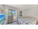 Well lit bedroom with an access door to the balcony and neutral paint, creating a serene and airy feel at 6157 Midnight Pass Rd # B42, Sarasota, FL 34242
