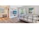 Bright bedroom with wood-look floors, large window, and decorative shelves create a comfortable and inviting space at 6157 Midnight Pass Rd # B42, Sarasota, FL 34242