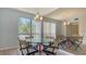 Bright dining room with large windows, chandelier, wood-look floors, and a decorative mirror at 6157 Midnight Pass Rd # B42, Sarasota, FL 34242