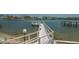 Exterior waterfront dock featuring a walkway, seating, and stunning views for residents' enjoyment at 6157 Midnight Pass Rd # B42, Sarasota, FL 34242