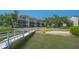 Community dock featuring building with water views and grassy area for outside enjoyment at 6157 Midnight Pass Rd # B42, Sarasota, FL 34242