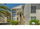 Charming condo exterior with wooden stairs and lush landscaping, offering a welcoming entrance and curb appeal at 6157 Midnight Pass Rd # B42, Sarasota, FL 34242