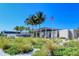 A daytime exterior view of the Sarasota County building with lush, colorful landscaping, and the American flag waving in the breeze at 6157 Midnight Pass Rd # B42, Sarasota, FL 34242