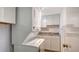 Convenient laundry room features a stacked washer and dryer with built in cabinets and countertops for storage at 6157 Midnight Pass Rd # B42, Sarasota, FL 34242