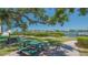 Community park featuring picnic tables, chairs, a walkway, and waterfront views for residents' enjoyment at 6157 Midnight Pass Rd # B42, Sarasota, FL 34242