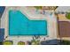 Aerial view of the community pool featuring lounge chairs, shade, and beautiful blue water at 6157 Midnight Pass Rd # B42, Sarasota, FL 34242