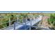 A wooden boardwalk leads to the sandy beach with lush greenery on either side and the blue ocean beyond at 6157 Midnight Pass Rd # B42, Sarasota, FL 34242