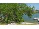 Scenic waterfront view showcases beautiful tree with boat dock and calm water, creating a peaceful atmosphere at 6157 Midnight Pass Rd # B42, Sarasota, FL 34242