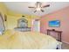 Bedroom with light pink and yellow walls featuring TV and dresser at 6330 Green Oak Cir, Bradenton, FL 34203