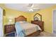 Bedroom with yellow walls, wooden bed and dresser, providing a cozy retreat at 6330 Green Oak Cir, Bradenton, FL 34203