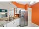 Stylish kitchen features granite countertops, stainless steel refrigerator and white cabinetry at 6330 Green Oak Cir, Bradenton, FL 34203