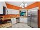 Modern kitchen with stainless steel appliances, white cabinets, granite counters, and open layout at 6330 Green Oak Cir, Bradenton, FL 34203