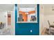 Open view from hall to kitchen, featuring white cabinetry and stainless steel appliances at 6330 Green Oak Cir, Bradenton, FL 34203