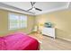 This bedroom features a tray ceiling, a view to the lake, and hardwood floors at 6713 Chester Trl, Bradenton, FL 34202
