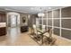 Bright dining room features a modern chandelier, decorative wall trim and a glass table set for four at 6713 Chester Trl, Bradenton, FL 34202
