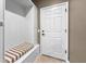 Entryway with built-in bench seating, coat storage, and a paneled door at 6713 Chester Trl, Bradenton, FL 34202