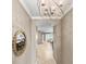Inviting hallway with decorative wall mirror leading to the living area and dining area at 6713 Chester Trl, Bradenton, FL 34202