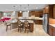 Open concept kitchen with stainless steel appliances, an island with barstool seating, and wood cabinetry at 6713 Chester Trl, Bradenton, FL 34202