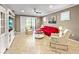 Cozy living room with a large flatscreen tv, ceiling fan, and bright accent chair at 6713 Chester Trl, Bradenton, FL 34202