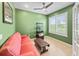 Bright office with a red couch, a ceiling fan, and bright window looking out to the outside at 6713 Chester Trl, Bradenton, FL 34202