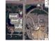 An aerial view shows a property near a large shopping center, lakes, and multiple condominium buildings at 6906 Simmons Loop, Riverview, FL 33578