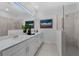 Sleek bathroom featuring a double vanity, a glass-enclosed shower, and tasteful decorations for a spa-like feel at 8134 Shore Lake Dr, Englewood, FL 34224