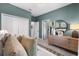 Inviting bedroom featuring calming colors, a stylish dresser, and a spacious closet for storage at 8134 Shore Lake Dr, Englewood, FL 34224