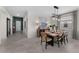 Inviting dining room with a modern table set, stylish lighting, and an open flow to other spaces at 8134 Shore Lake Dr, Englewood, FL 34224