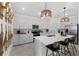 Gourmet kitchen features sleek white cabinetry, stainless appliances, and a quartz countertop island at 8134 Shore Lake Dr, Englewood, FL 34224