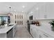 Bright kitchen boasts white cabinets, quartz countertops, and a spacious layout for cooking at 8134 Shore Lake Dr, Englewood, FL 34224