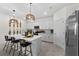 Well-appointed kitchen features a large island, stainless steel appliances, and modern pendant lighting at 8134 Shore Lake Dr, Englewood, FL 34224