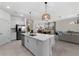 Open kitchen with modern appliances, a center island, and seamless flow into the living spaces at 8134 Shore Lake Dr, Englewood, FL 34224