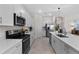 Stylish kitchen boasts stainless steel appliances, quartz countertops, and ample cabinet space at 8134 Shore Lake Dr, Englewood, FL 34224