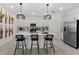 Modern kitchen with an island, stainless steel appliances, and pendant lighting at 8134 Shore Lake Dr, Englewood, FL 34224