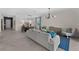 Spacious living area with modern furnishings, tiled floors, and an open layout connected to the dining room at 8134 Shore Lake Dr, Englewood, FL 34224
