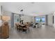 Open-concept living and dining area with elegant furnishings, tiled flooring, and a view of the water at 8134 Shore Lake Dr, Englewood, FL 34224