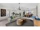 Spacious living room flows into the kitchen and dining area, complete with modern lighting fixtures and neutral decor at 8134 Shore Lake Dr, Englewood, FL 34224