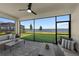 Covered patio offers serene lake views, with comfortable seating perfect for outdoor relaxation and entertaining at 8134 Shore Lake Dr, Englewood, FL 34224