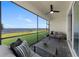 Screened patio with ceiling fan offers lake views and comfortable seating area at 8134 Shore Lake Dr, Englewood, FL 34224