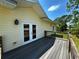 Spacious deck with wooden railing and double doors leading to the house in a beautiful outdoor setting at 8297 Strasse Blvd, Punta Gorda, FL 33982