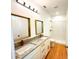 Elegant bathroom with double sinks, granite countertop, modern fixtures, and spacious walk-in shower at 8297 Strasse Blvd, Punta Gorda, FL 33982