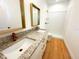Elegant bathroom with double sinks, granite countertop, modern fixtures, and spacious walk-in shower at 8297 Strasse Blvd, Punta Gorda, FL 33982